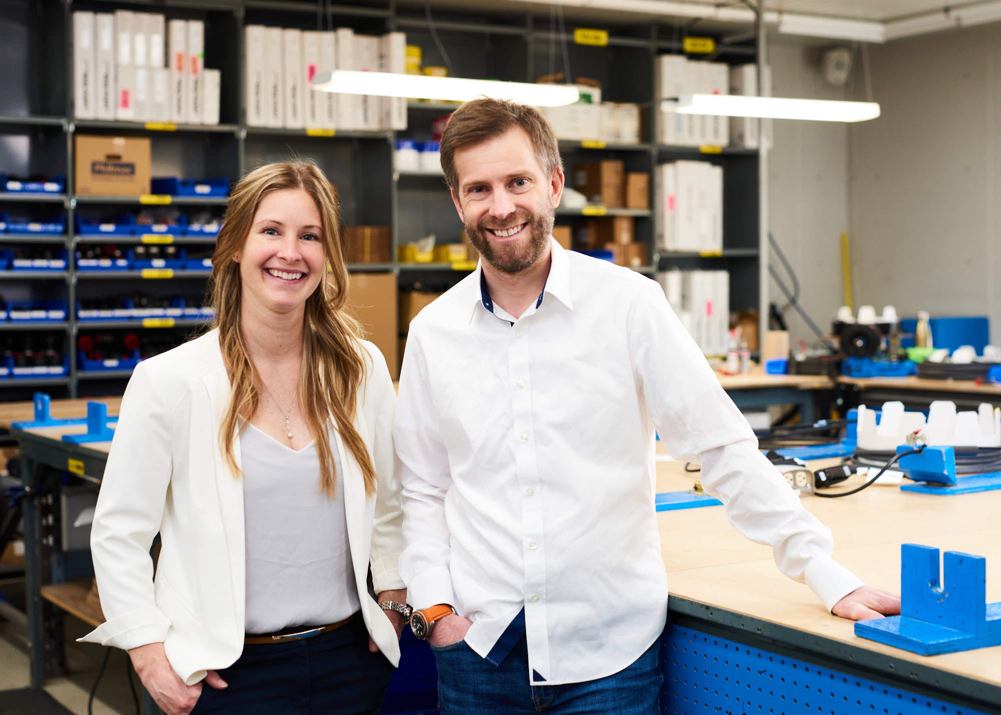 Portrait of two smiling corporate business executives in industrial manufacturing plant