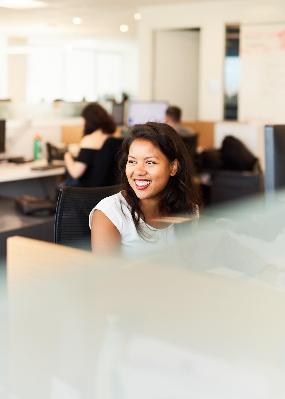 Candid corporate photograph of smiling Toronto business woman in office