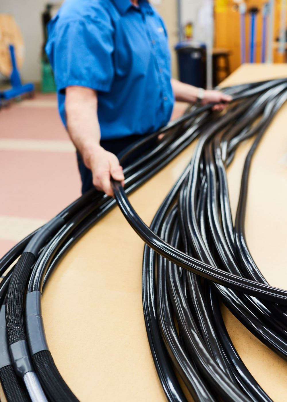 industrial-worker-moving-tubing-in-manufacturing-plant