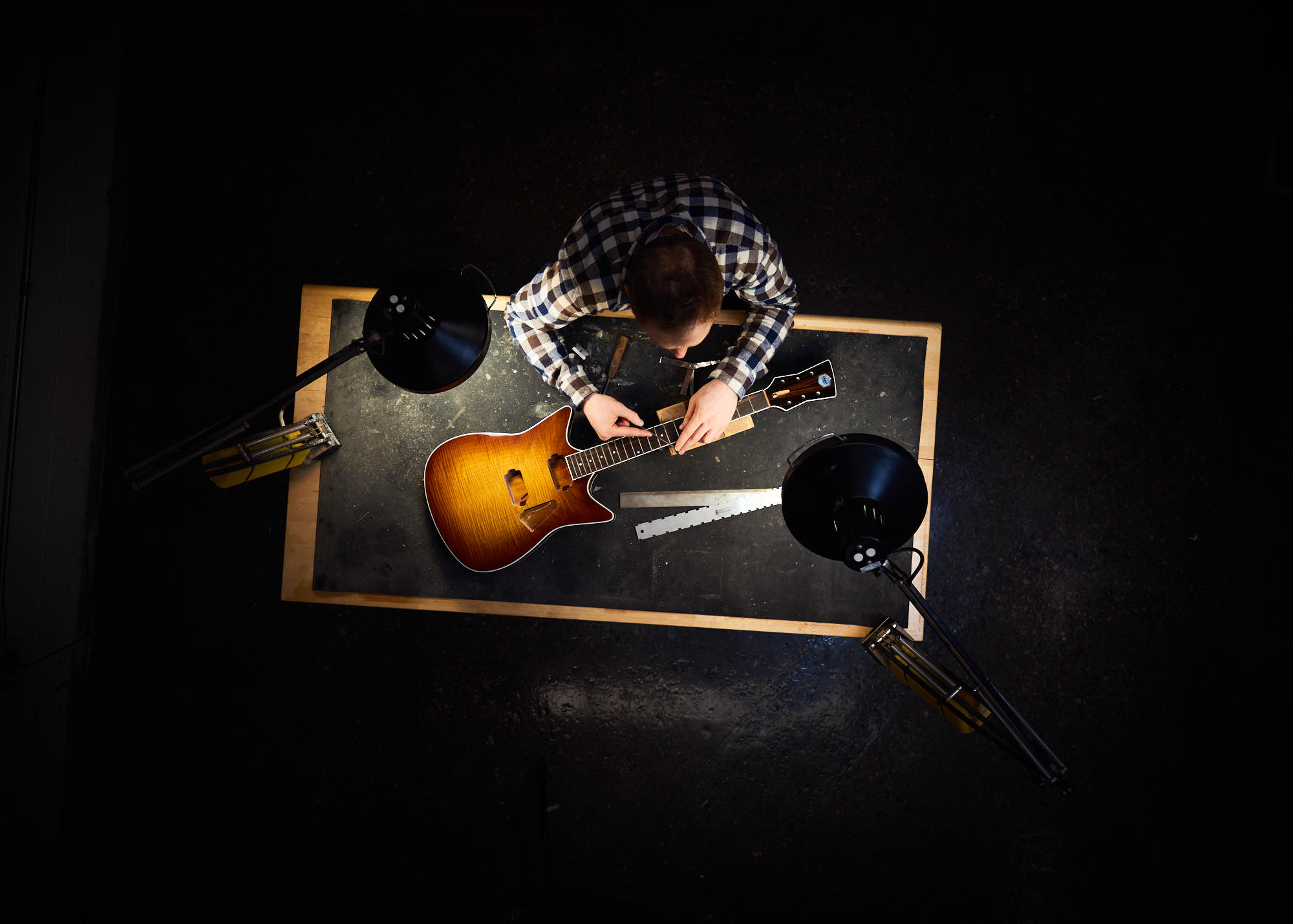 Overhead photograph of Toronto small business guitar owner assembling instrument