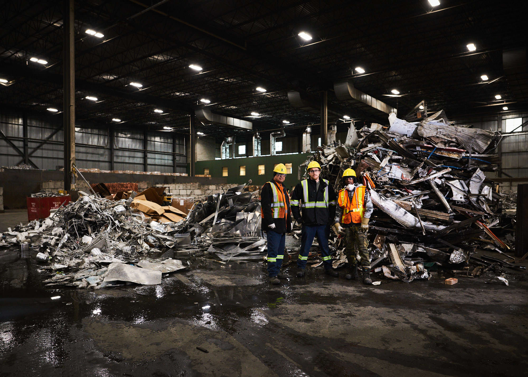 Portrait photograph of three male industrial workers in Toronto manufacturing and recycling plant