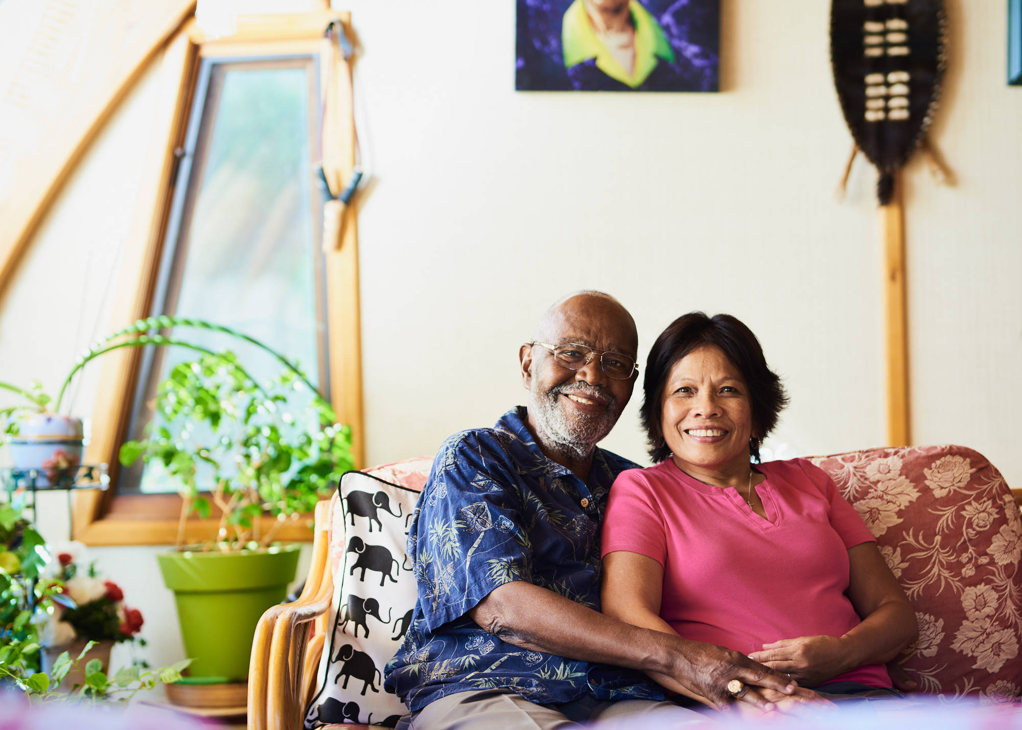 retired-couple-sitting-on-couch-at-home