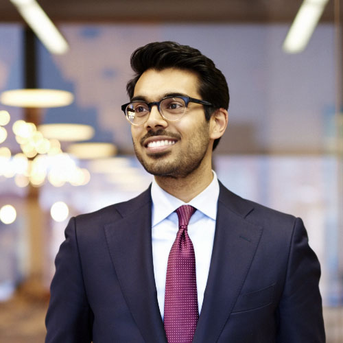 Young male investor business portrait in modern glass office