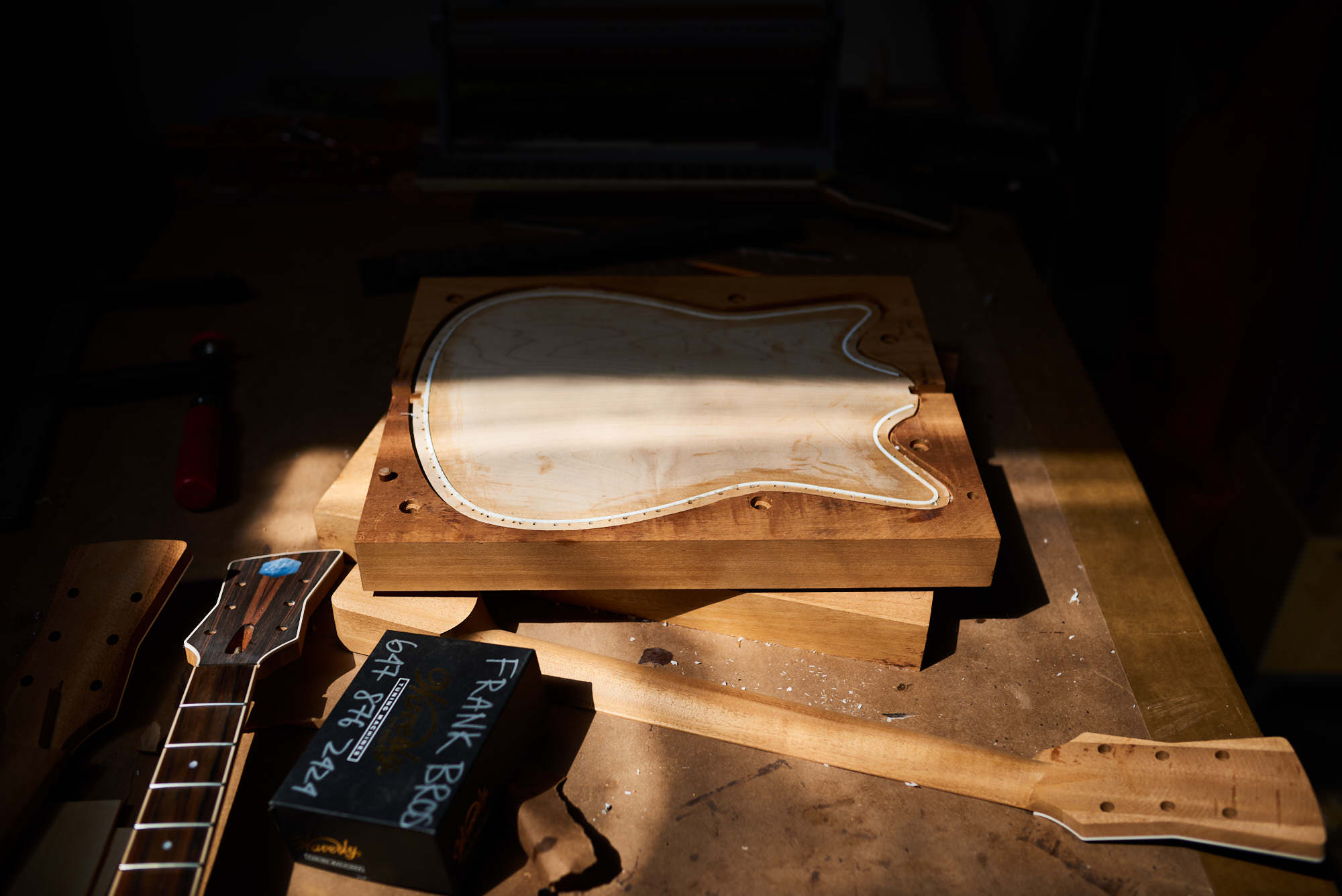 Photograph of guitar being made in small business studio