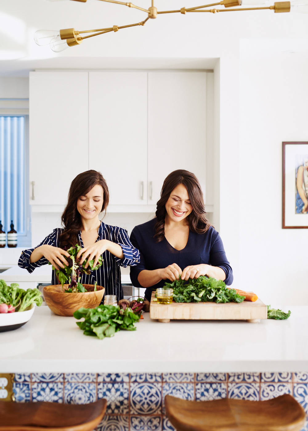 Lifestyle photography of two female small business owners preparing food in modern kitchen