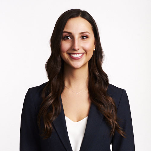 Business portrait of young smiling female lawyer on white background